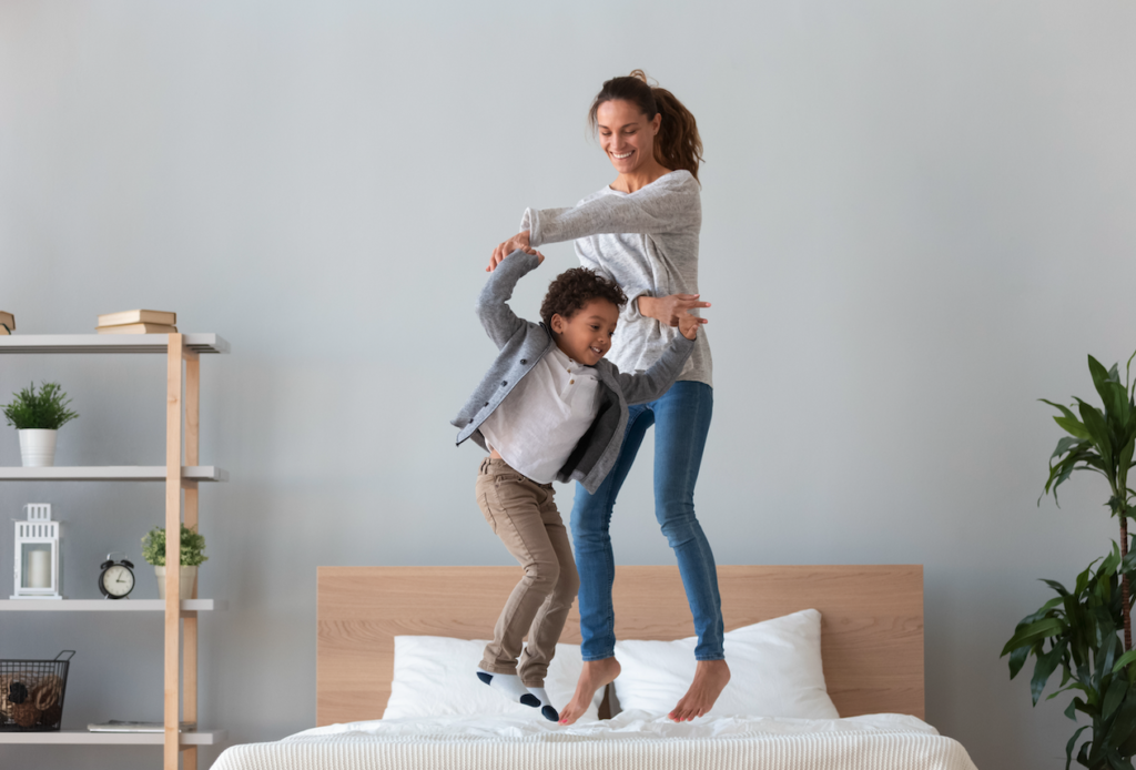 Mom and child jumping on the bed